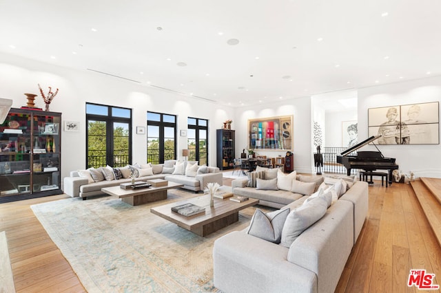 living room featuring french doors and light hardwood / wood-style flooring