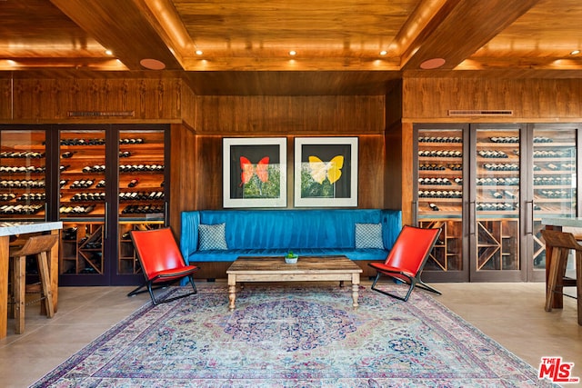 wine room with tile patterned flooring, wood ceiling, and wooden walls