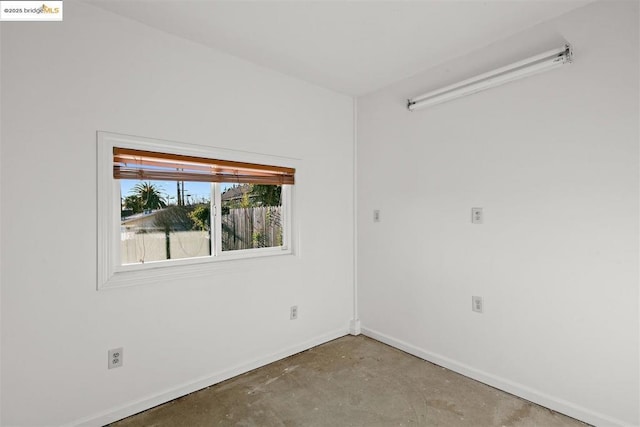 spare room with concrete floors