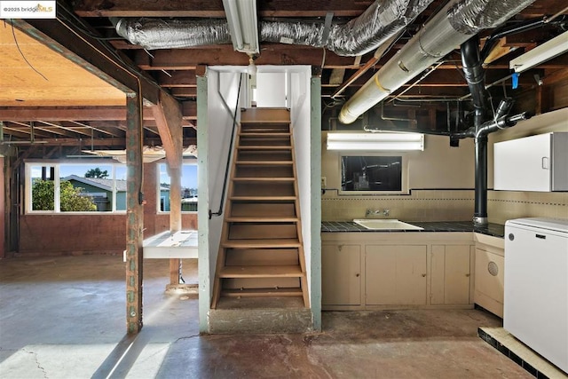 basement featuring fridge and sink