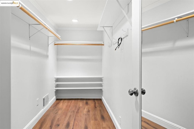 spacious closet with dark hardwood / wood-style floors