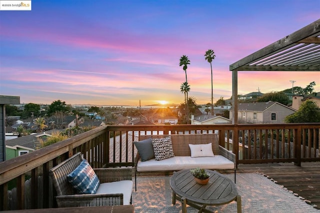 deck at dusk with an outdoor living space