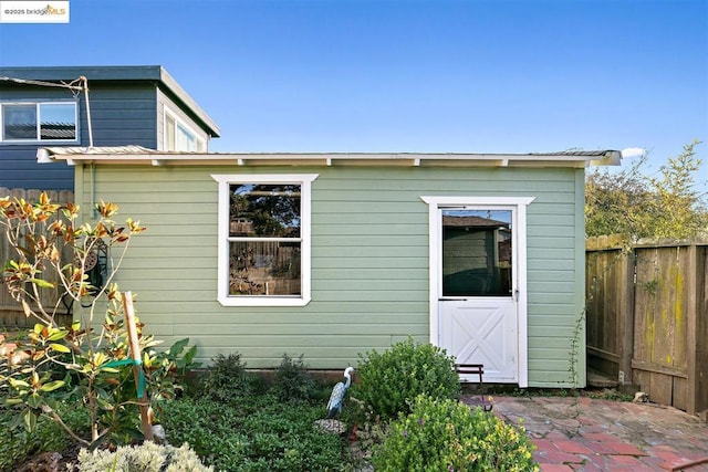 exterior space featuring an outbuilding and a patio area