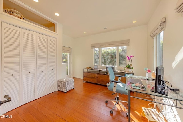 home office with hardwood / wood-style flooring and a healthy amount of sunlight