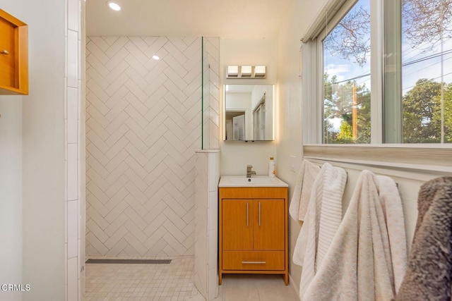 bathroom with vanity, a shower, and tile patterned floors