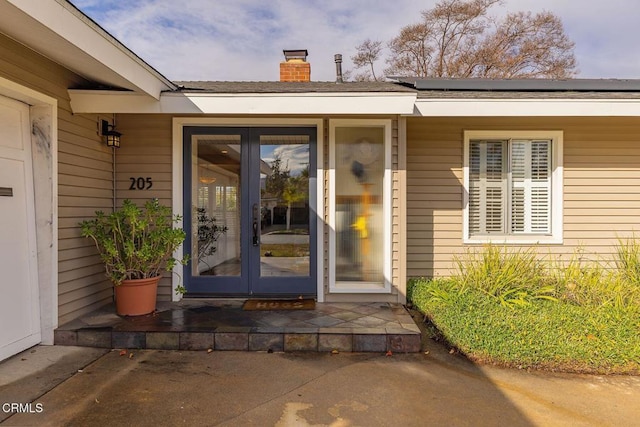 entrance to property featuring a patio and french doors