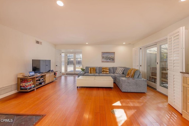 living room featuring hardwood / wood-style flooring and french doors