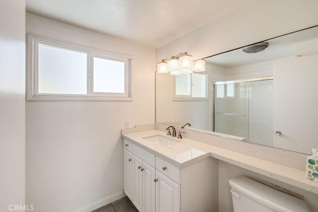 bathroom with toilet, vanity, tile patterned floors, and walk in shower