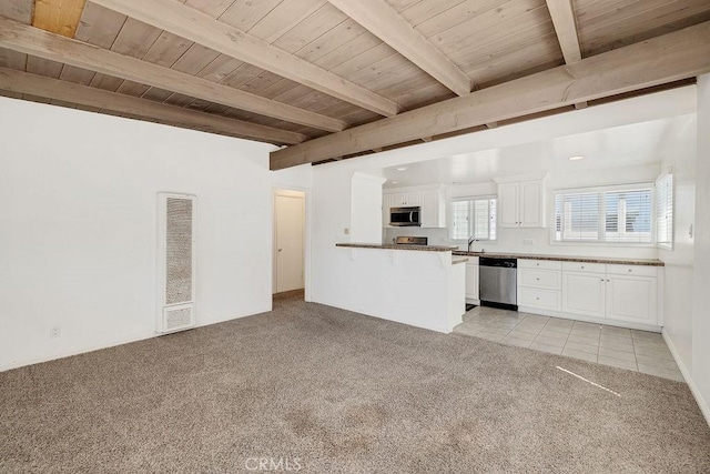 unfurnished living room featuring beam ceiling, sink, wood ceiling, and light colored carpet