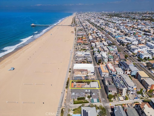 birds eye view of property with a water view and a view of the beach