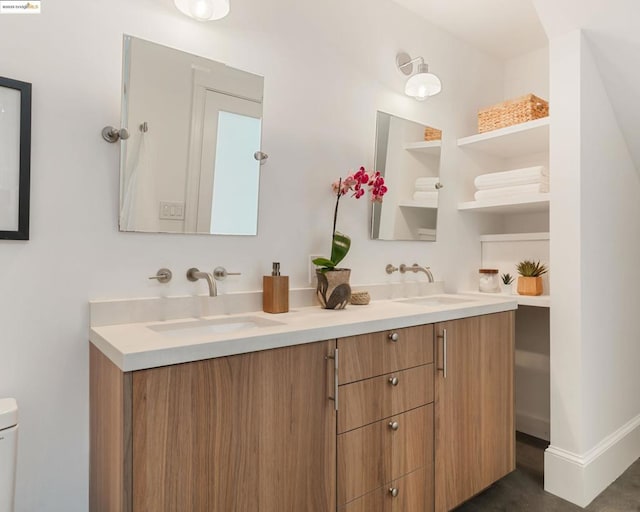 bathroom featuring vanity and toilet