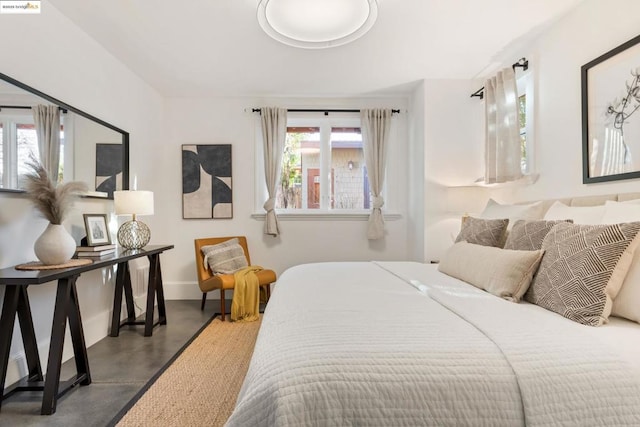 bedroom featuring concrete floors