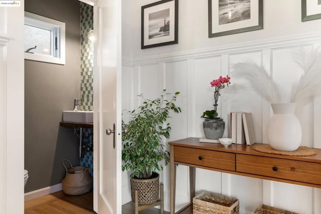 mudroom featuring wood-type flooring and sink