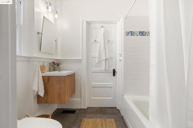 full bathroom with vanity, shower / tub combo with curtain, tile patterned floors, and toilet