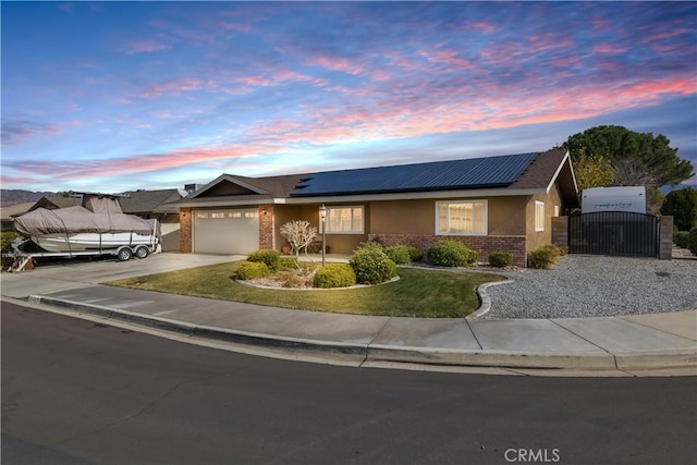 view of front facade with a garage and solar panels