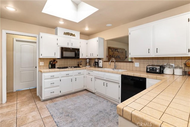 kitchen with white cabinetry, sink, and black appliances