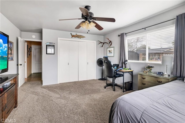 carpeted bedroom with a closet and ceiling fan