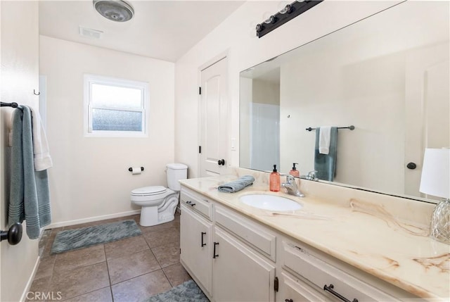 bathroom with vanity, tile patterned floors, and toilet