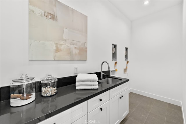 bar featuring sink and white cabinets