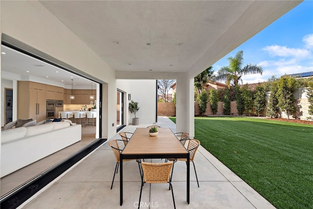 view of patio with an outdoor living space and an outdoor kitchen