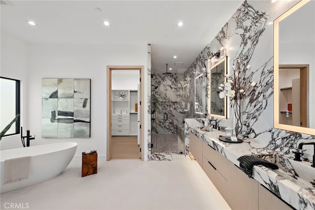 bathroom featuring sink and independent shower and bath