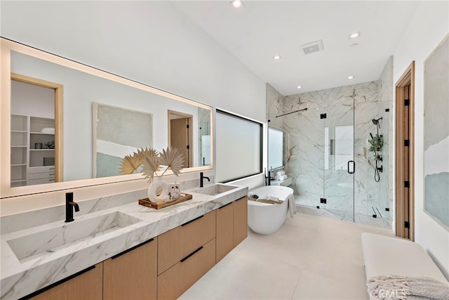 bathroom with vanity and separate shower and tub