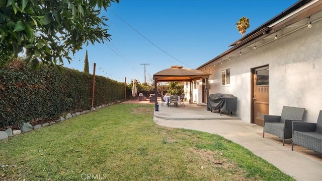 view of yard featuring a gazebo, a patio area, and a fenced backyard