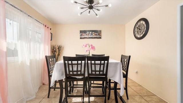 tiled dining area with an inviting chandelier