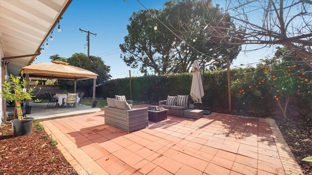 view of patio / terrace with a gazebo and an outdoor living space with a fire pit