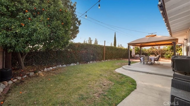 view of yard with a fenced backyard, a patio, and a gazebo