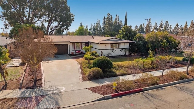 single story home featuring a garage and driveway