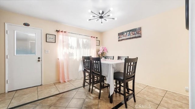 dining space featuring tile patterned flooring and a notable chandelier