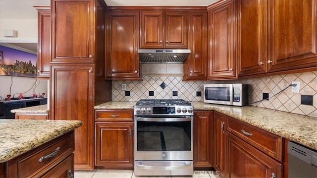 kitchen featuring light stone counters, light tile patterned floors, decorative backsplash, and stainless steel appliances