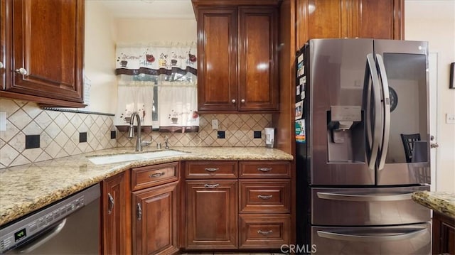 kitchen with sink, dishwasher, stainless steel refrigerator with ice dispenser, tasteful backsplash, and light stone counters