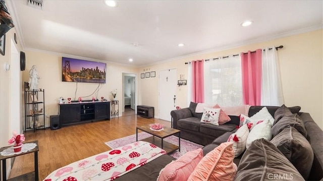 living room featuring crown molding and wood-type flooring