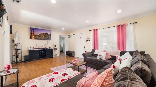 living room with ornamental molding, recessed lighting, visible vents, and wood finished floors