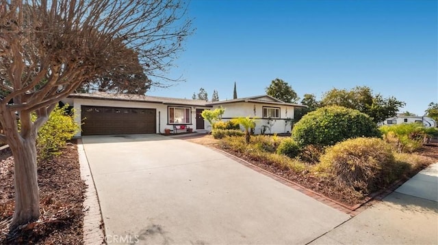 single story home with driveway and an attached garage