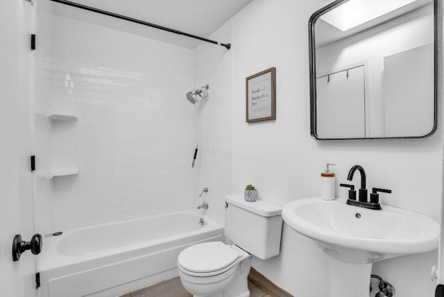 full bathroom featuring sink, shower / tub combination, and toilet