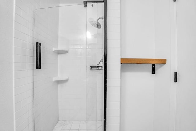 interior details featuring a shower with shower door