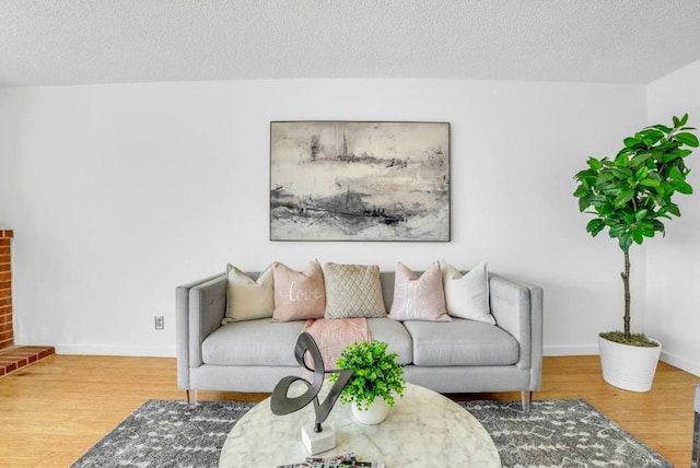 living room with hardwood / wood-style flooring and a textured ceiling