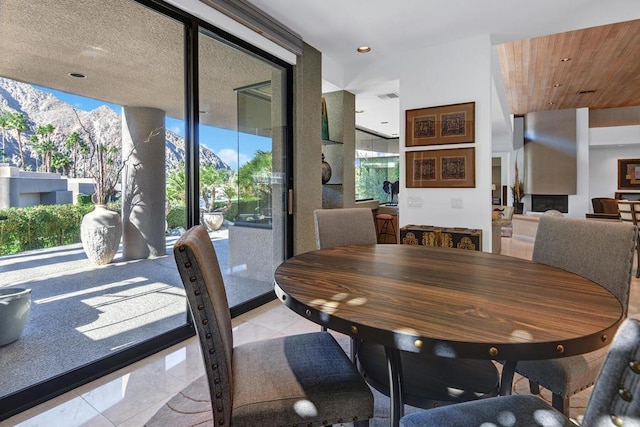 dining space featuring a mountain view and light tile patterned floors