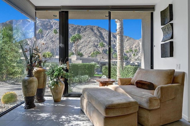 sitting room featuring floor to ceiling windows and a mountain view