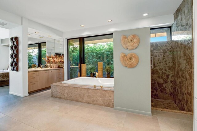 bathroom featuring vanity, independent shower and bath, and tile patterned flooring