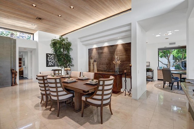 dining room with plenty of natural light and wooden ceiling