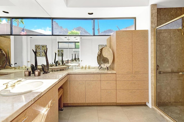 bathroom featuring vanity, a shower with shower door, and tile patterned floors