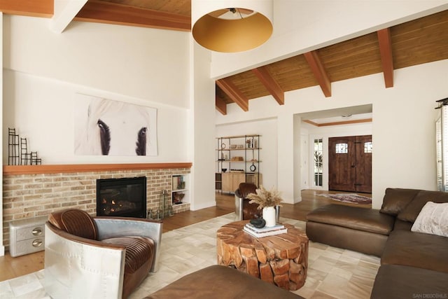 living room featuring vaulted ceiling with beams, wood ceiling, and a fireplace