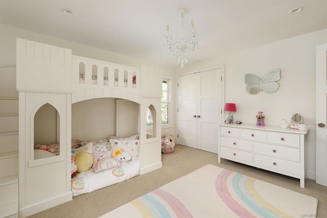 carpeted bedroom with a chandelier and a closet