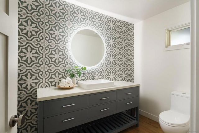 bathroom with vanity, wood-type flooring, and toilet