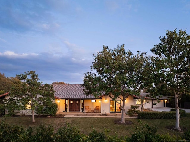 view of front facade with a garage and a lawn