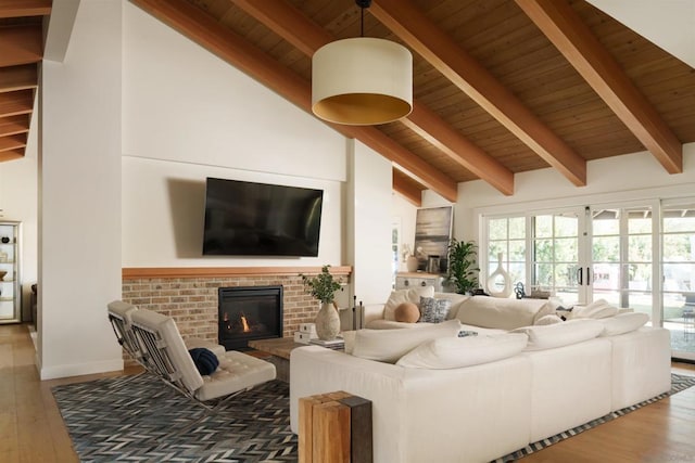 living room with lofted ceiling with beams, wood-type flooring, wooden ceiling, and a fireplace